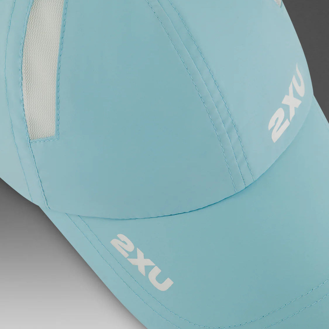 Light blue cap with '2XU' branding on a gray background